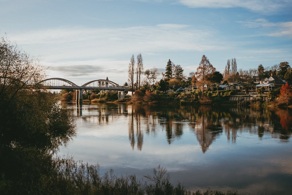 Beautiful autumn scene of the Waikato River with Fairfield Bridge and quaint houses in Hamilton, New Zealand.